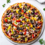 Paleo cauliflower rice pizza on white background in modern kitchen